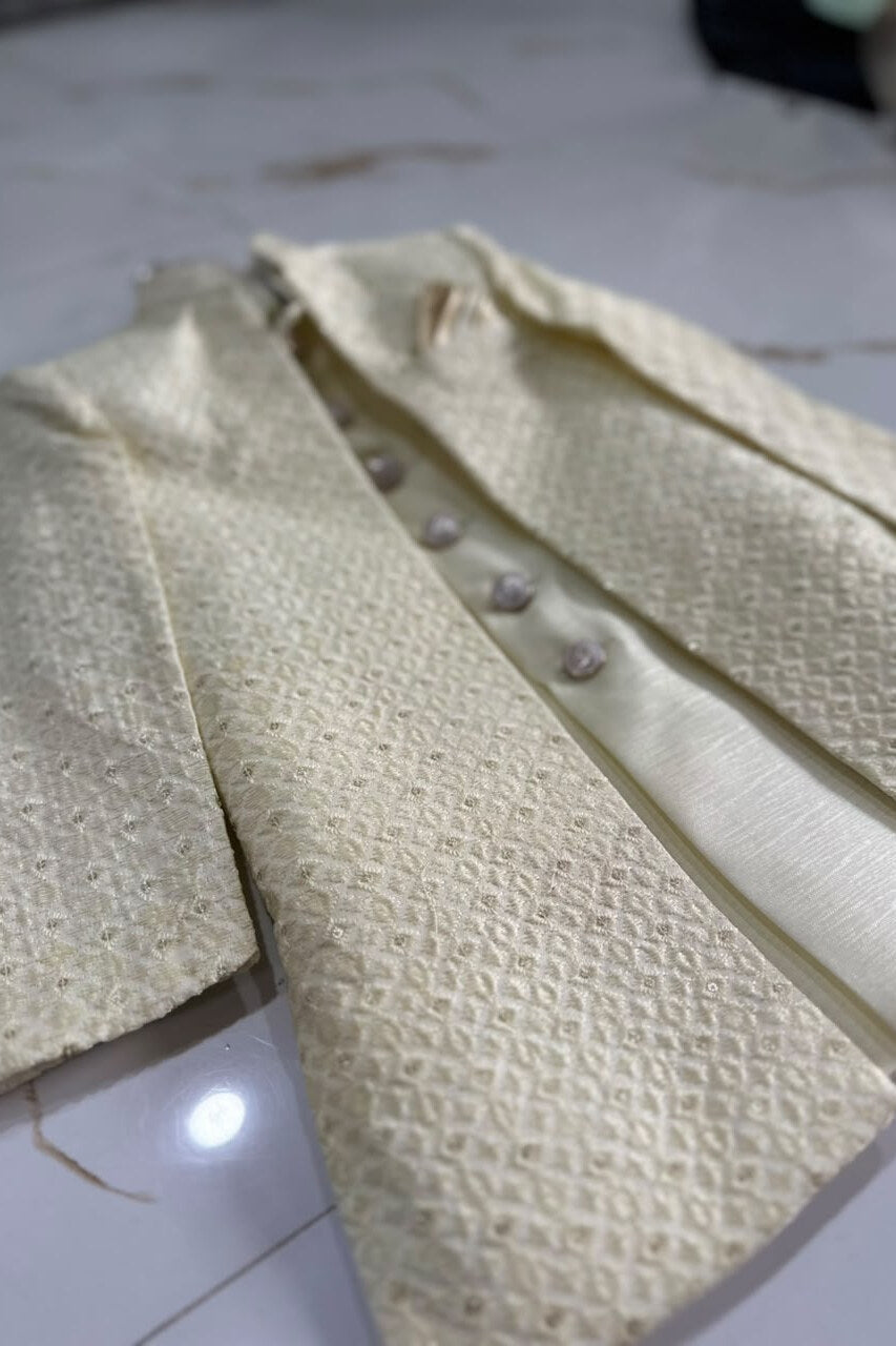 Real close-up of ivory sherwani fabric, buttons and inner suit