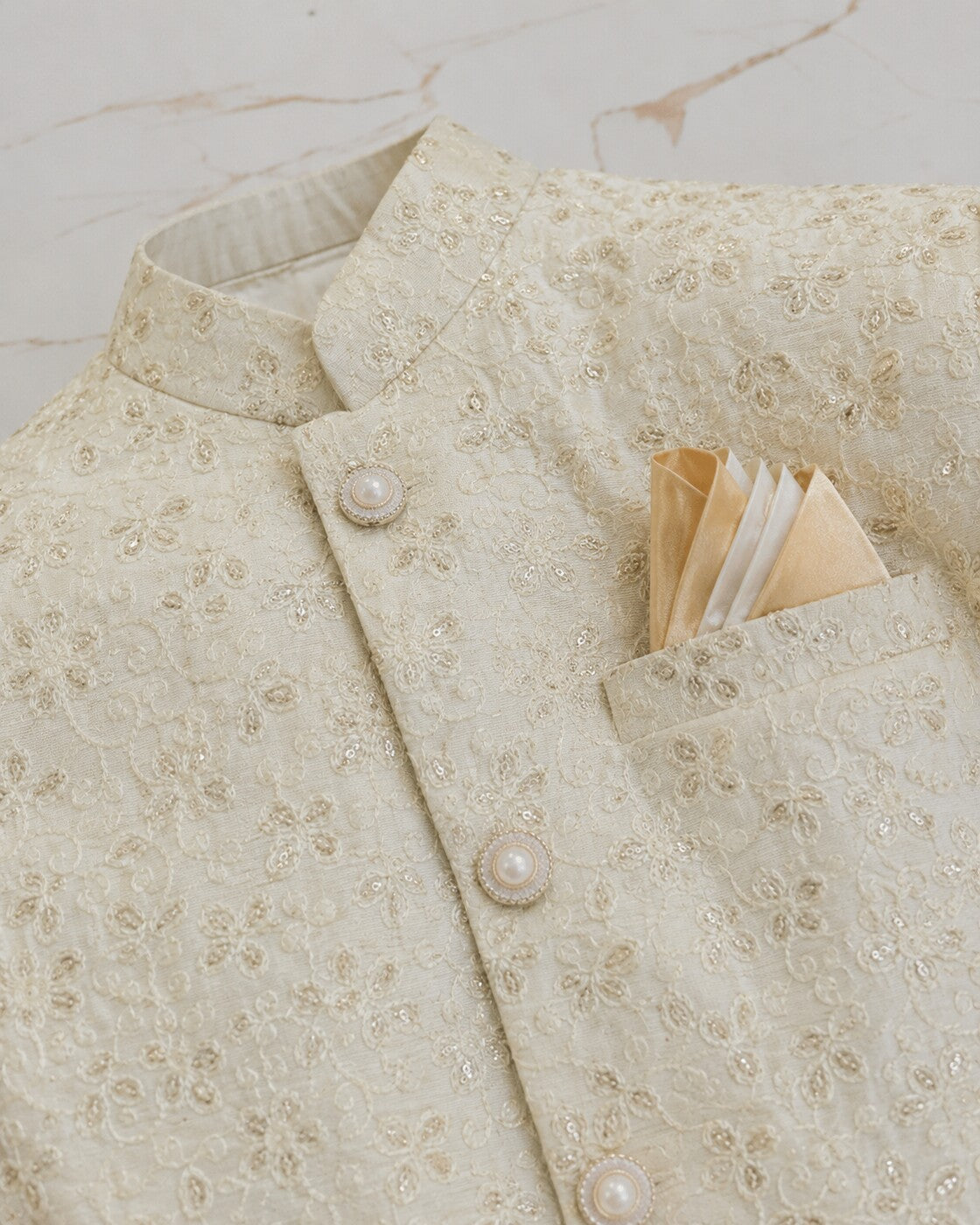 Noor-e-Shehzada white Sherwani embroidery, buttons and pocket-square detail