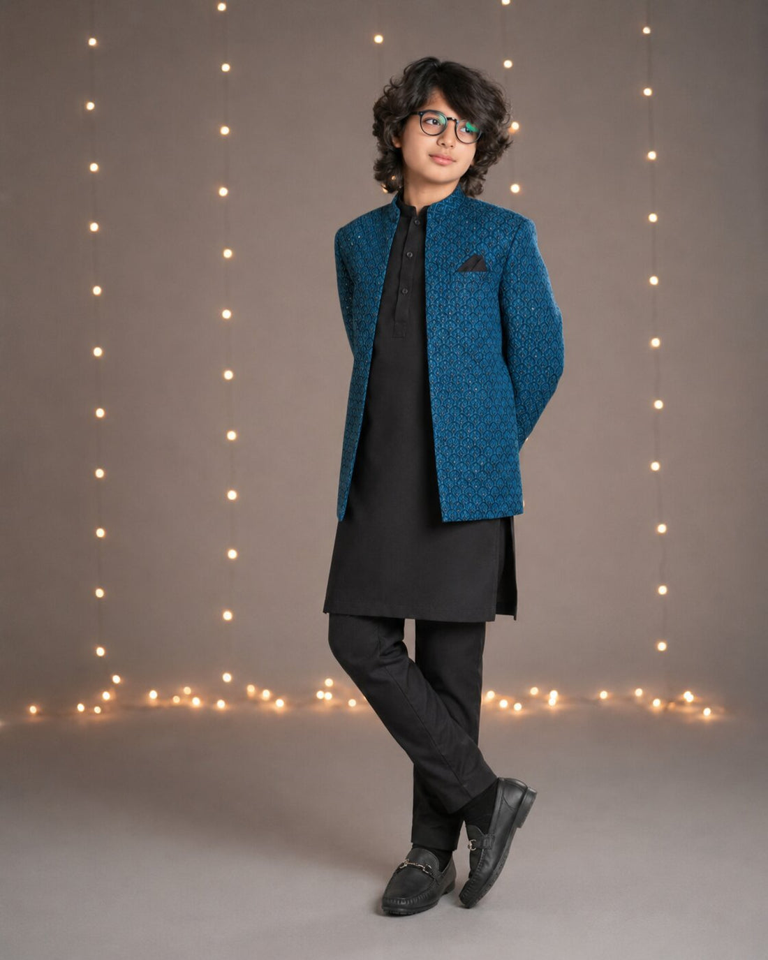 Boy wearing teal blue embroidered Prince Coat with black kurta trouser — full look