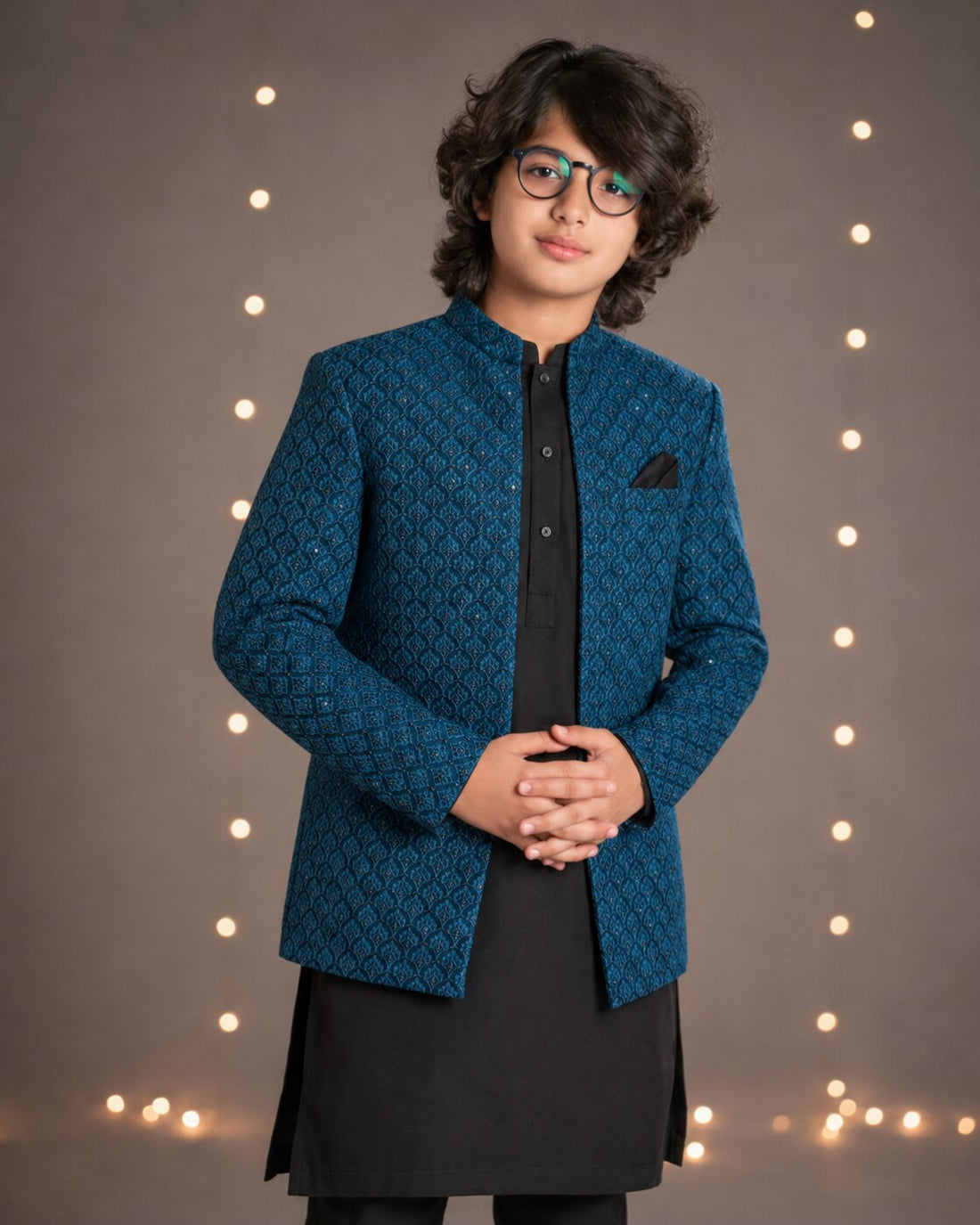 Boy wearing teal blue embroidered Prince Coat with black kurta trouser — full look